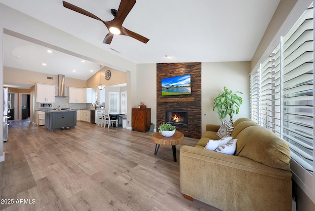 26647 N 43rd St N, Cave Creek, AZ 85331 - living area featuring lofted ceiling, a ceiling fan, a fireplace, and light wood-style floors