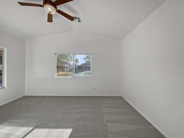 empty room featuring ceiling fan, carpet floors, and vaulted ceiling