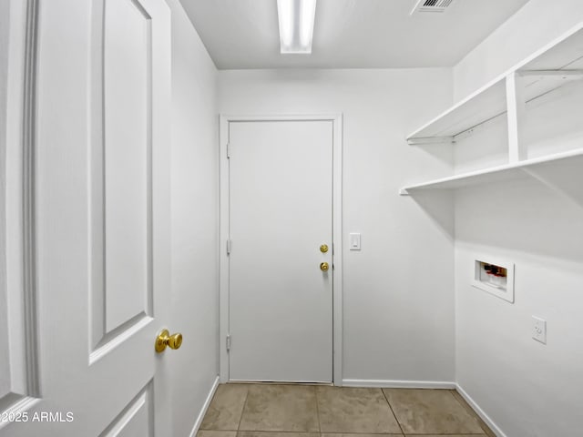 clothes washing area featuring light tile patterned floors and hookup for a washing machine