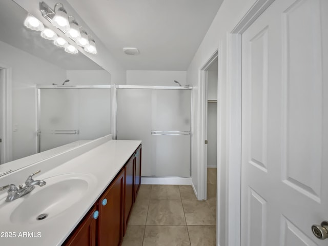 bathroom featuring vanity, tile patterned floors, and a shower with shower door