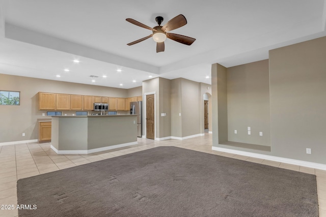 unfurnished living room with ceiling fan and light tile patterned floors