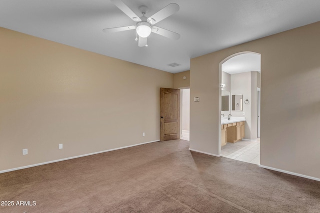 carpeted spare room with ceiling fan