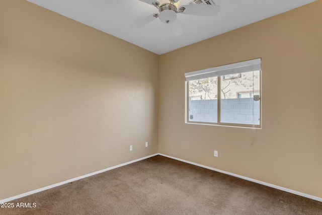 spare room with ceiling fan and carpet floors