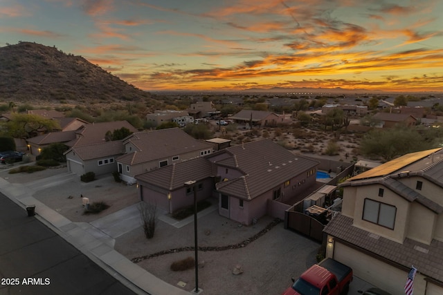 aerial view at dusk featuring a mountain view