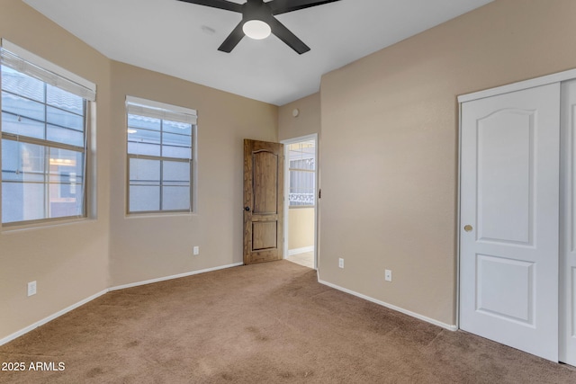 unfurnished bedroom featuring light carpet and ceiling fan