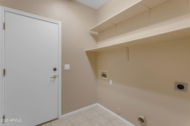 washroom with hookup for a gas dryer, electric dryer hookup, washer hookup, and light tile patterned floors