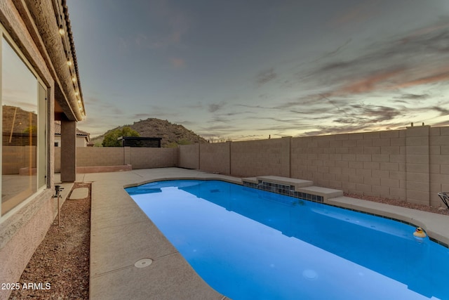 view of pool at dusk