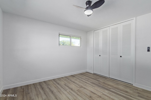 unfurnished bedroom with ceiling fan, a closet, and light hardwood / wood-style flooring