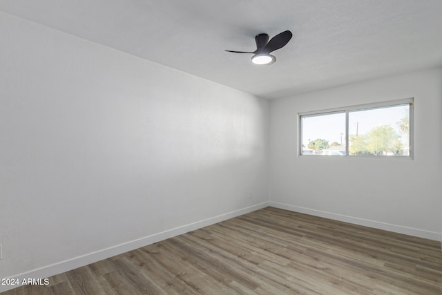 unfurnished room featuring hardwood / wood-style flooring and ceiling fan