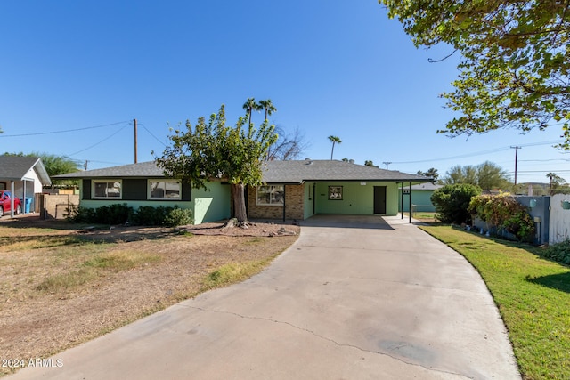 single story home with a carport and a front yard