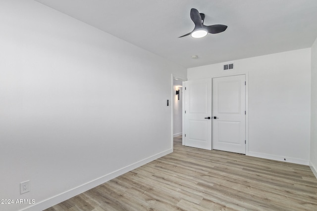 spare room featuring light wood-type flooring and ceiling fan