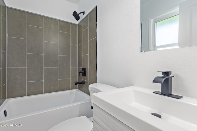 full bathroom featuring vanity, toilet, and tiled shower / bath