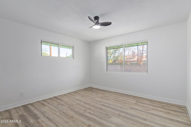 spare room featuring light hardwood / wood-style flooring and ceiling fan