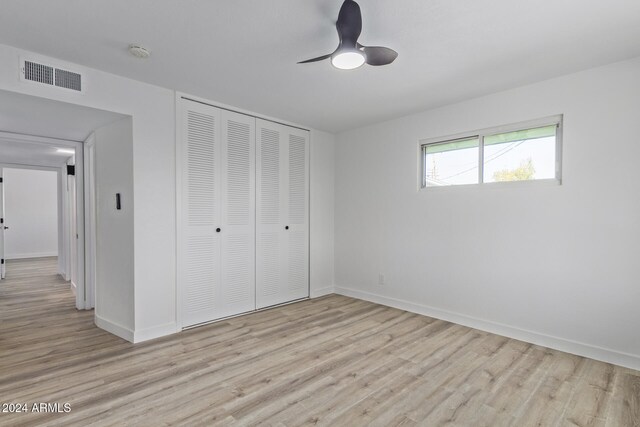 unfurnished bedroom with a closet, ceiling fan, and light hardwood / wood-style flooring