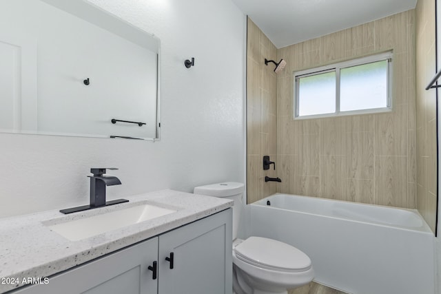 full bathroom featuring toilet, vanity, and tiled shower / bath