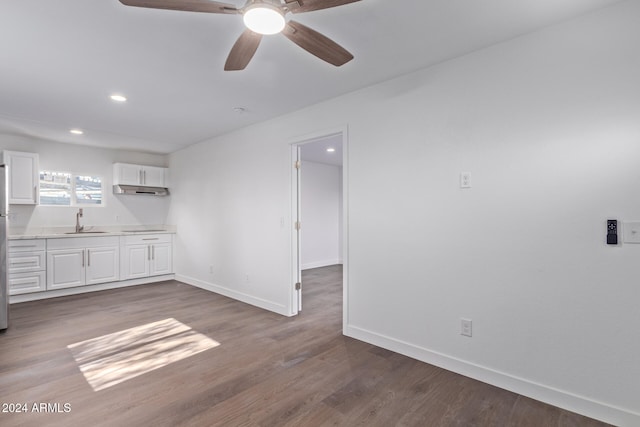 interior space with ceiling fan, sink, and dark hardwood / wood-style floors