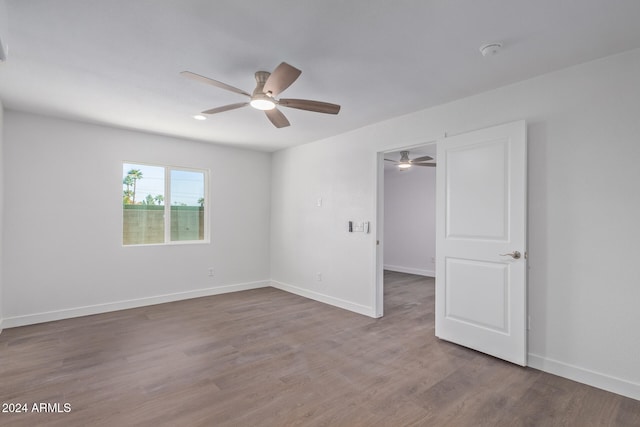 empty room with ceiling fan and wood-type flooring