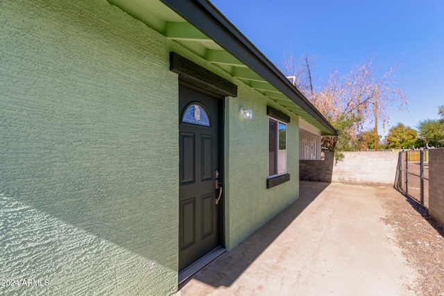 property entrance featuring a patio