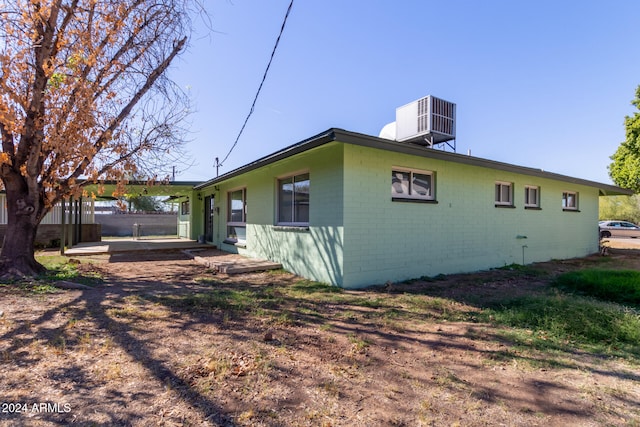 view of side of home featuring central air condition unit and a patio area