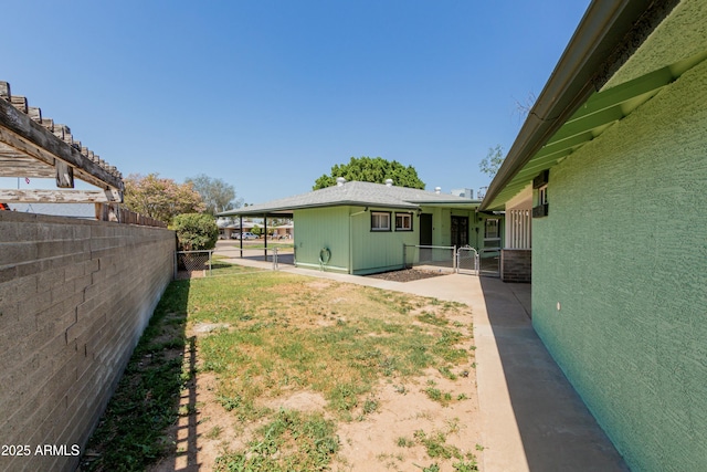 view of yard with fence and a gate