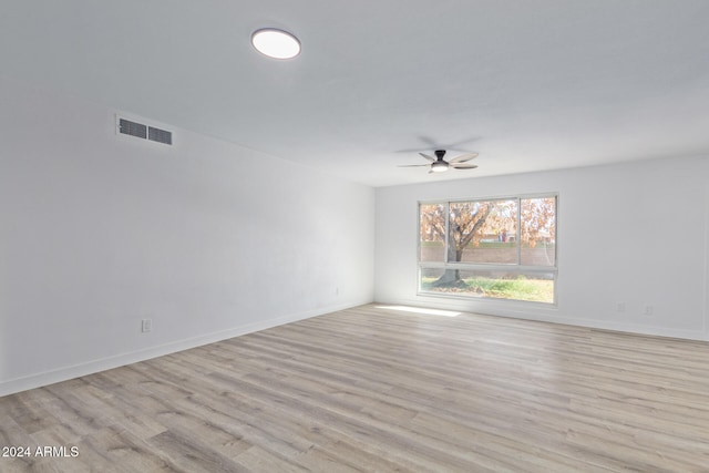 spare room featuring light wood-type flooring and ceiling fan