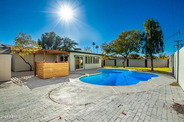 view of pool with a fenced in pool, a fenced backyard, and a patio area