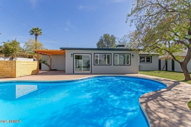 back of property featuring a patio area, a fenced in pool, a pergola, and fence