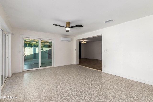 empty room featuring visible vents, a ceiling fan, and a wall unit AC