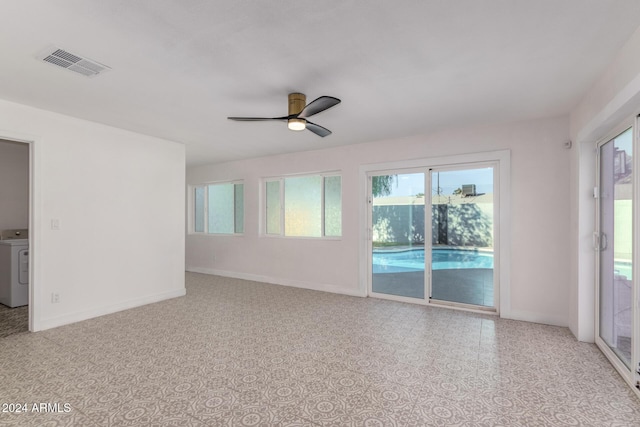 spare room featuring visible vents, washer / clothes dryer, baseboards, and ceiling fan