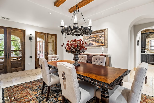 dining room featuring an inviting chandelier, french doors, and beam ceiling