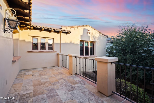 view of balcony at dusk