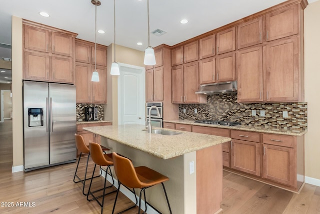 7630 E Knoll St, Mesa, AZ 85207 - kitchen featuring a center island with sink, stainless steel appliances, visible vents, a sink, and under cabinet range hood