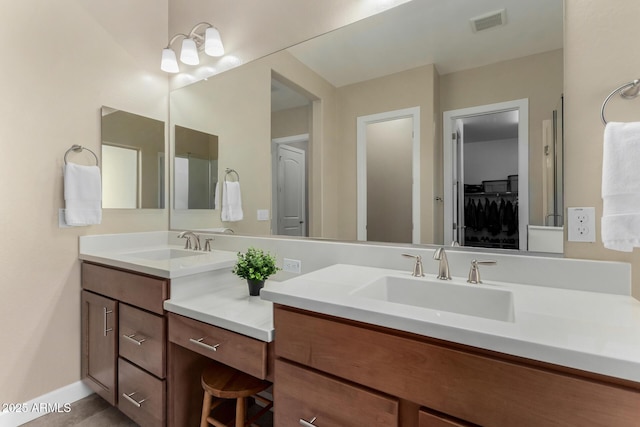 7630 E Knoll St, Mesa, AZ 85207 - full bathroom with baseboards, a spacious closet, visible vents, and vanity