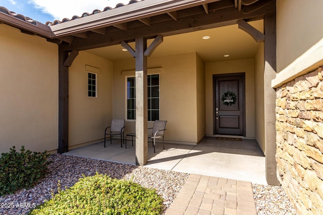 7630 E Knoll St, Mesa, AZ 85207 - doorway to property featuring a tile roof, stone siding, a patio area, and stucco siding