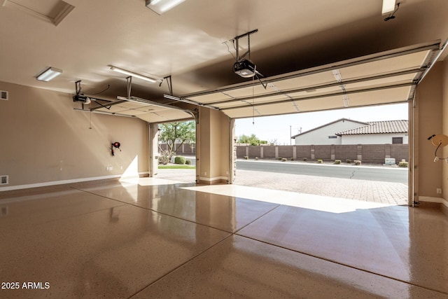 7630 E Knoll St, Mesa, AZ 85207 - garage featuring visible vents, baseboards, and a garage door opener