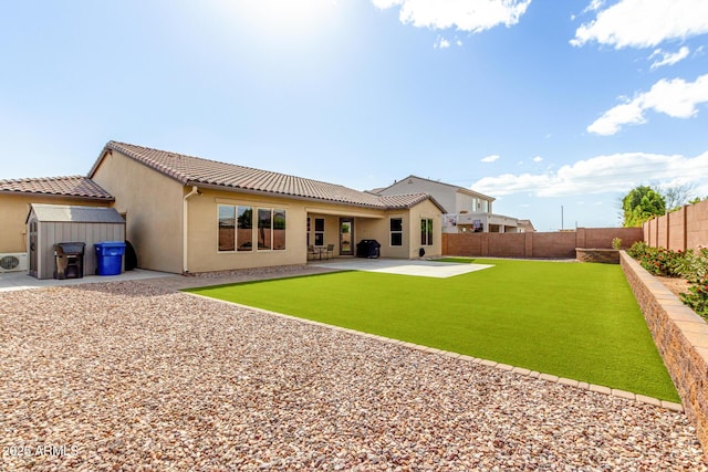 7630 E Knoll St, Mesa, AZ 85207 - back of property with an outbuilding, a patio, stucco siding, a storage unit, and a fenced backyard