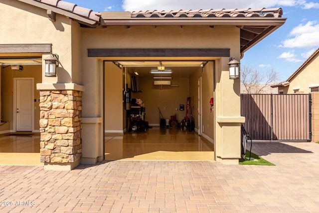 7630 E Knoll St, Mesa, AZ 85207 - doorway to property featuring stucco siding, fence, a garage, stone siding, and a tiled roof