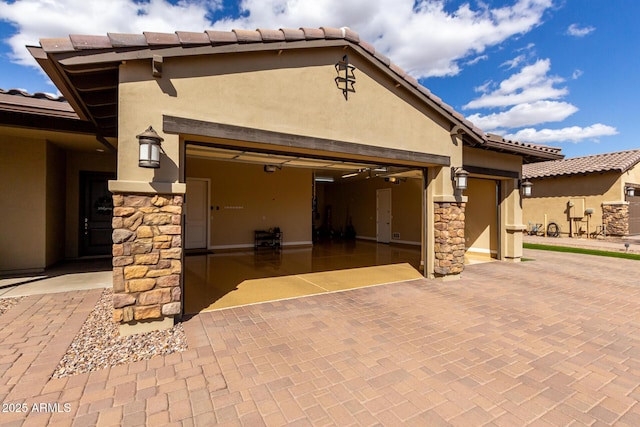 7630 E Knoll St, Mesa, AZ 85207 - exterior space with stone siding, decorative driveway, an attached garage, and stucco siding