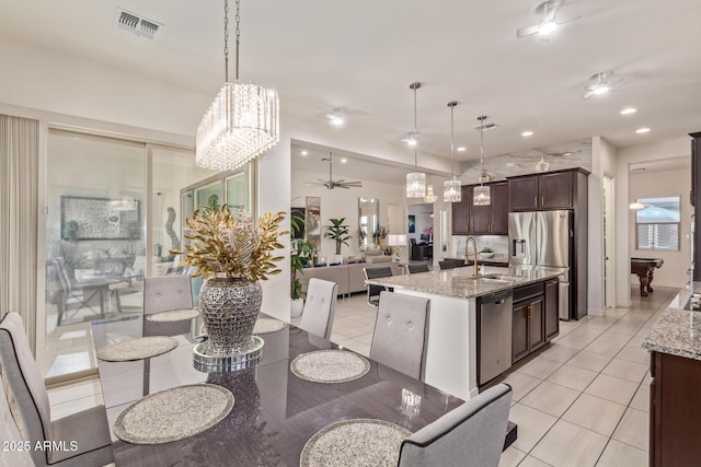5218 N Tiller Dr, Litchfield Park, AZ 85340 - dining room featuring ceiling fan, light tile patterned flooring, a chandelier, and recessed lighting