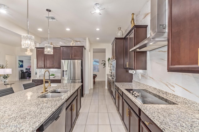 5218 N Tiller Dr, Litchfield Park, AZ 85340 - kitchen featuring wall chimney exhaust hood, appliances with stainless steel finishes, a sink, pendant lighting, and light stone countertops