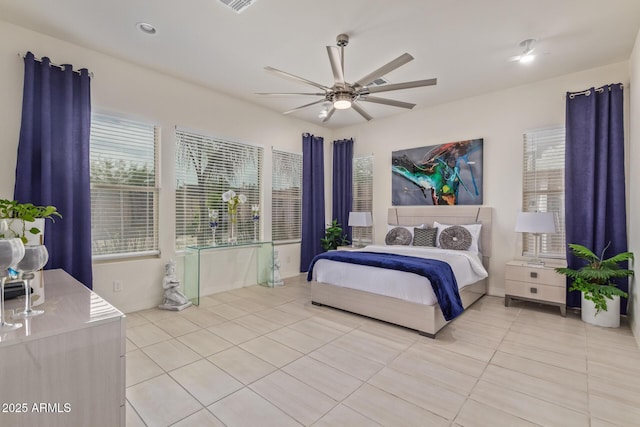 5218 N Tiller Dr, Litchfield Park, AZ 85340 - bedroom with light tile patterned floors and a ceiling fan