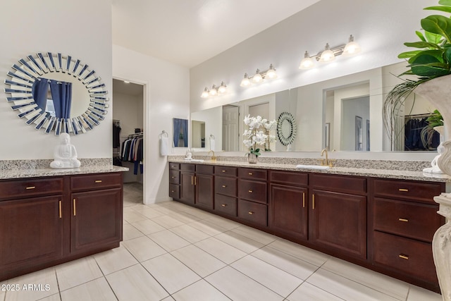 5218 N Tiller Dr, Litchfield Park, AZ 85340 - full bathroom with double vanity, tile patterned flooring, and a walk in closet