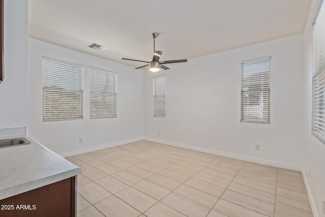 5218 N Tiller Dr, Litchfield Park, AZ 85340 - unfurnished dining area featuring light tile patterned floors, a ceiling fan, and baseboards