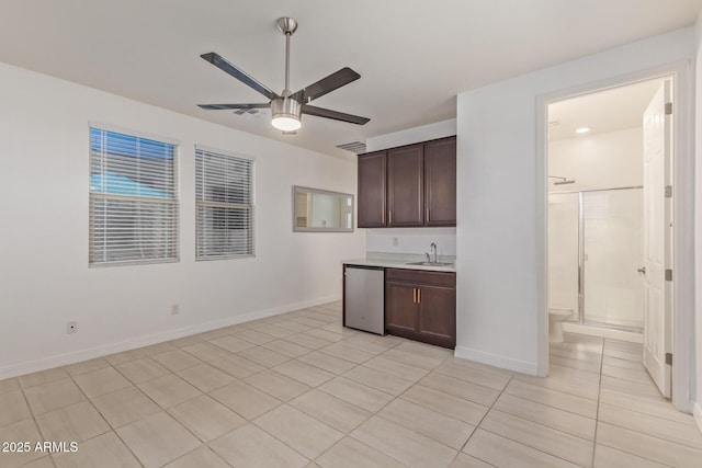 5218 N Tiller Dr, Litchfield Park, AZ 85340 - kitchen with a sink, a ceiling fan, dark brown cabinets, dishwasher, and light countertops