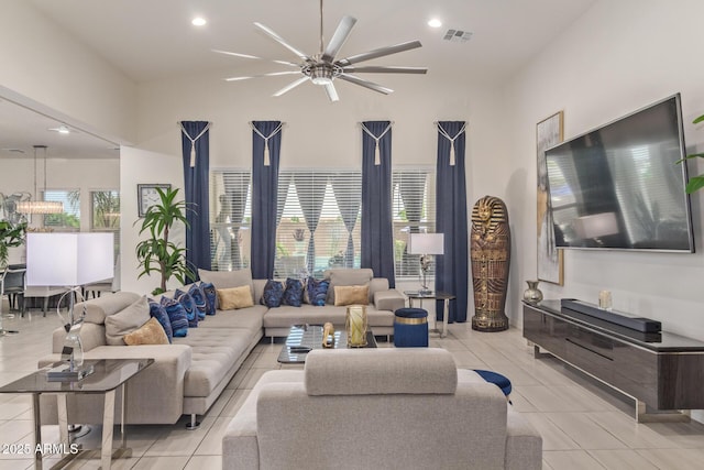 5218 N Tiller Dr, Litchfield Park, AZ 85340 - living room featuring light tile patterned flooring, ceiling fan, recessed lighting, and a high ceiling