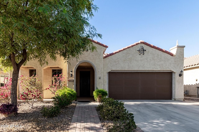 mediterranean / spanish-style house featuring a garage