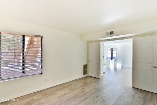 spare room featuring light hardwood / wood-style flooring