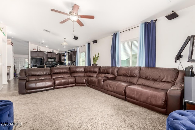 living room featuring vaulted ceiling and ceiling fan