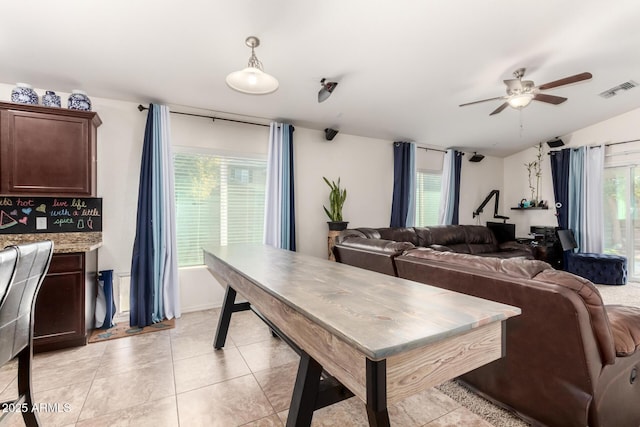 dining area with light tile patterned floors and ceiling fan