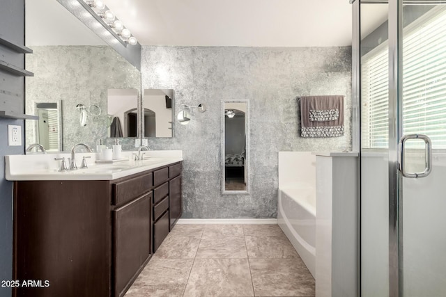 bathroom with tile patterned floors, vanity, and a bathing tub